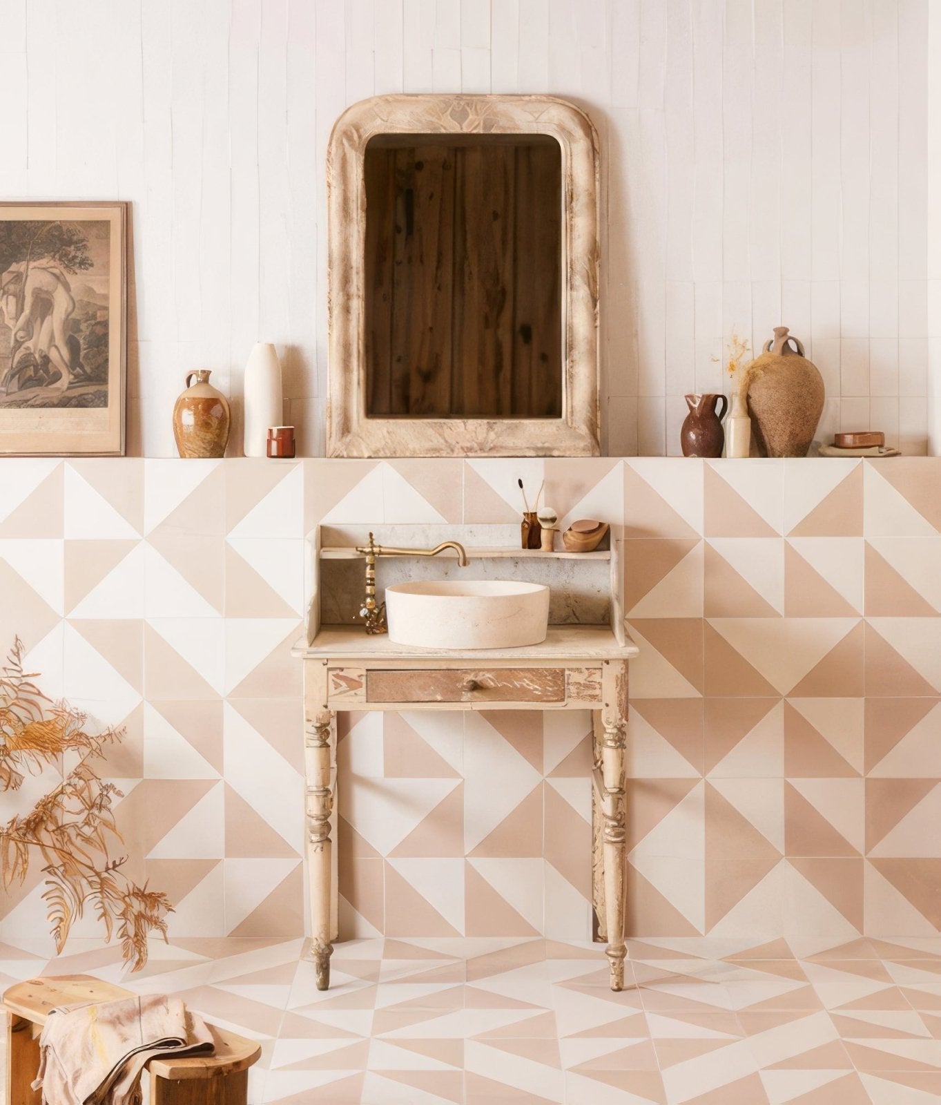 Vintage-style wooden vanity with white ceramic sink and ornate gold faucet complementing beige bathroom tiles