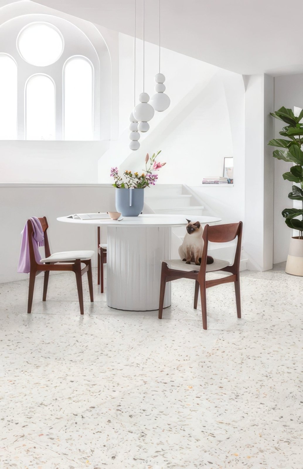 White cylindrical table with vertical ridges and glossy finish featured in lvt flooring ideas for your home article