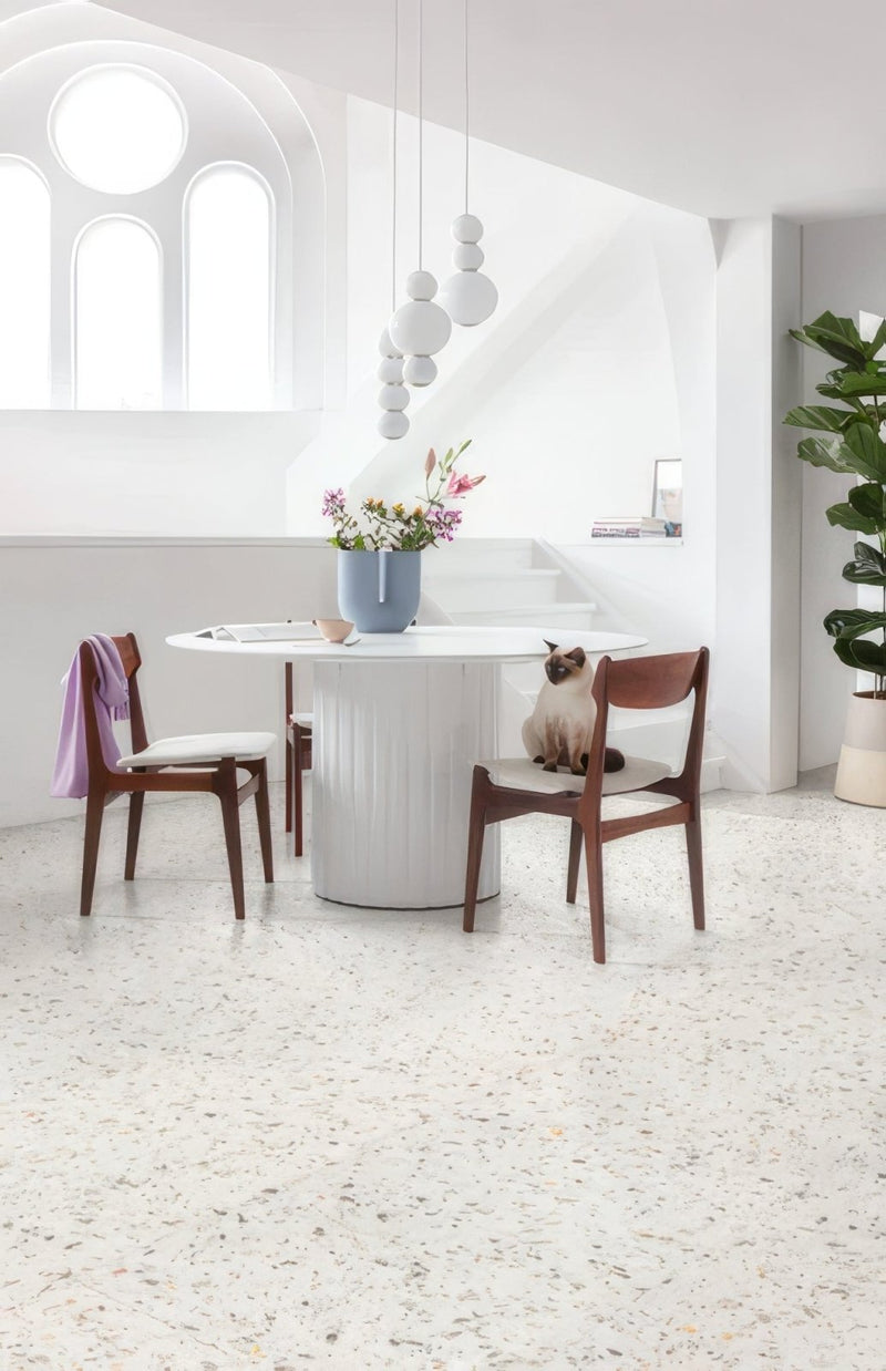 White cylindrical table with vertical ridges and glossy finish featured in lvt flooring ideas for your home article