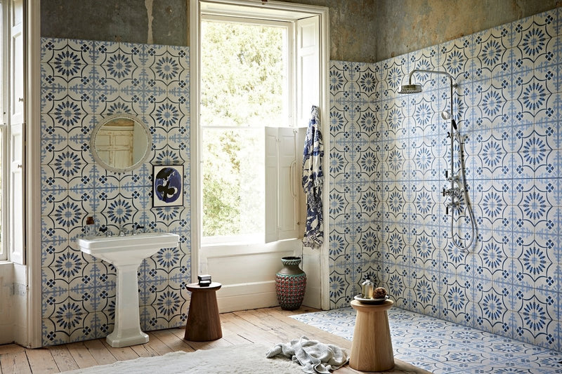 Blue and white patterned ceramic tiles with geometric floral design covering bathroom walls for stylish home transformation