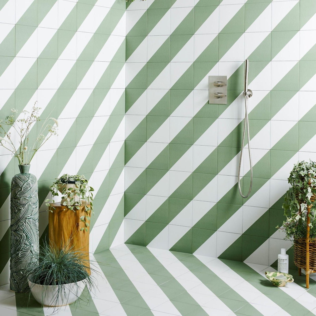 Green and white diagonal-striped ceramic floor and wall tiles commonly used in bathroom interiors
