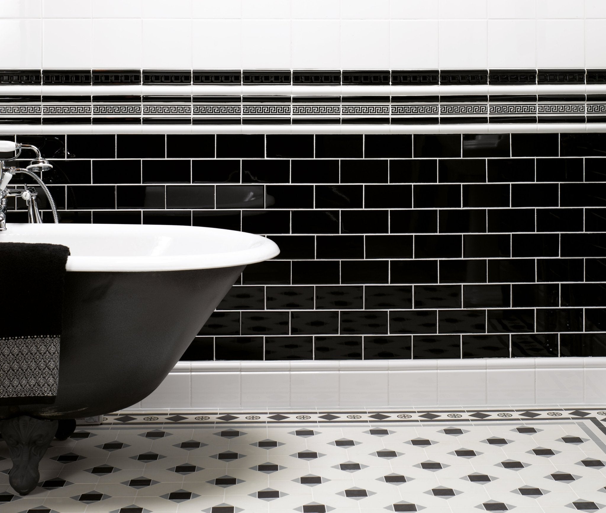 Black and white subway tile backsplash with decorative greek key border in ceramic for kitchen walls