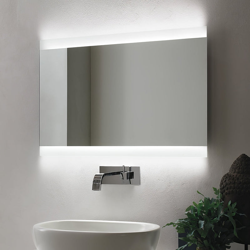 Rectangular frameless bathroom mirror with integrated LED lighting on top and bottom edges in illuminated bathroom mirrors.