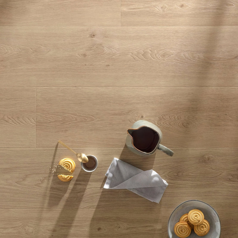 Light oak luxury vinyl tiles with subtle grain patterns and natural knots in rigid core wood effect flooring