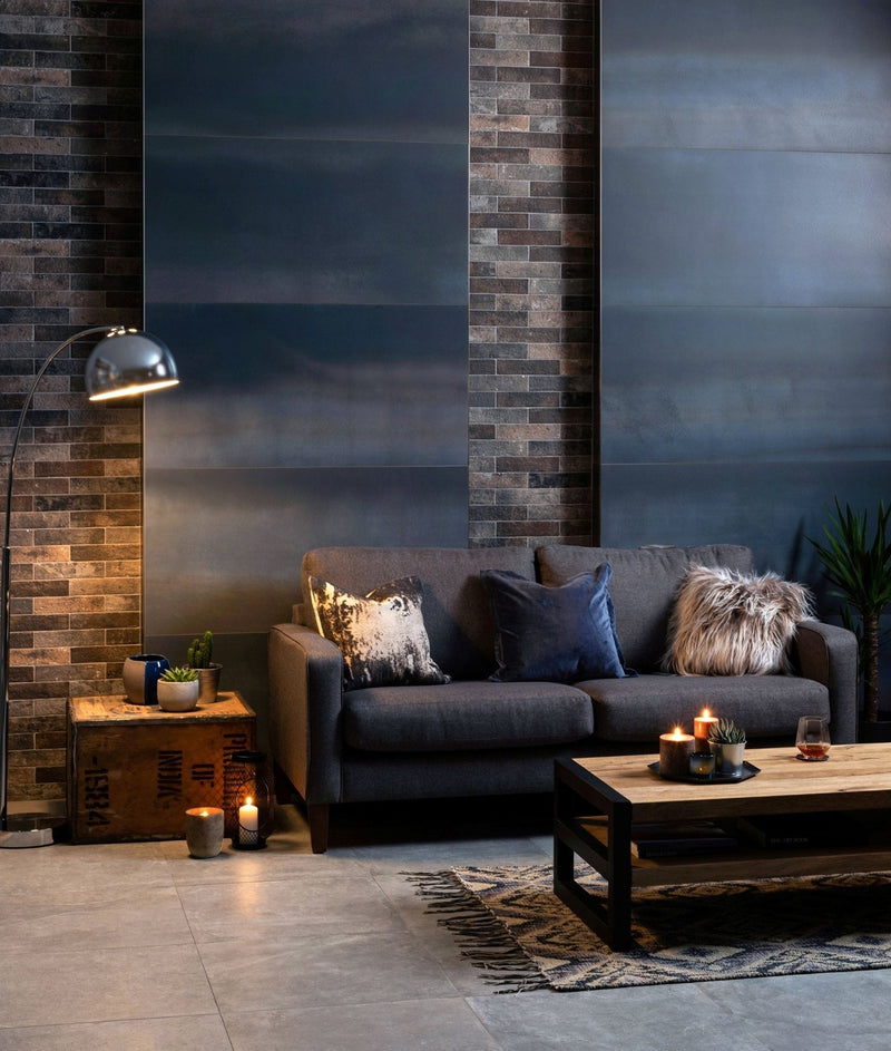 Dark gray velvet sofa with textured throw pillows and faux fur accent pillow in metal effect tiles collection