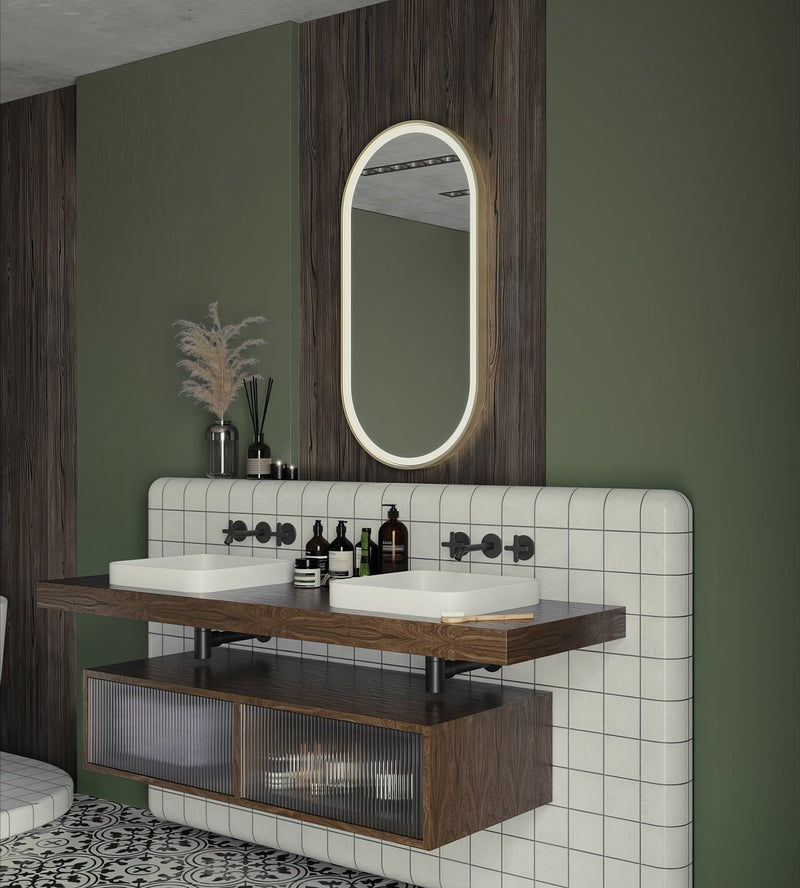 Modern oval mirror with a glowing white LED frame set against dark wood paneling from the oval mirrors collection.