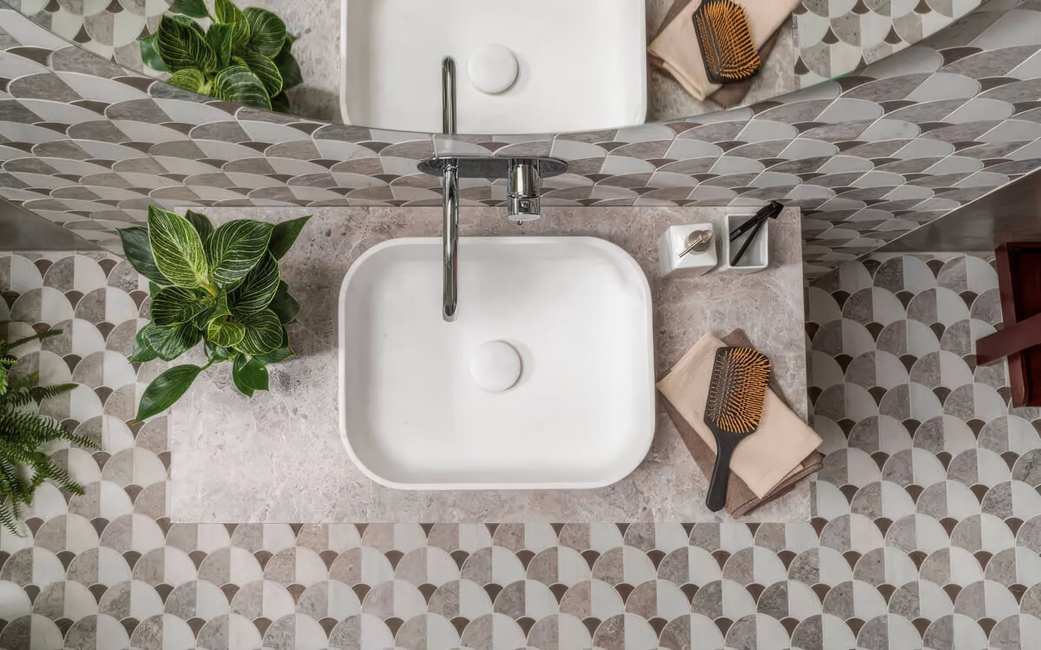 White square ceramic sink with sleek chrome faucet paired with scallop floor tiles in modern bathroom setting