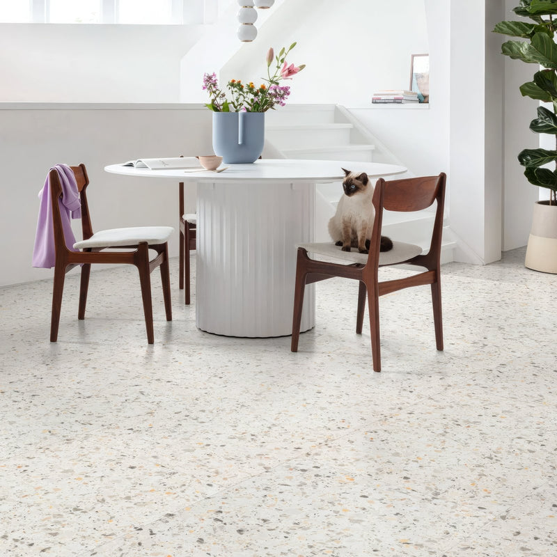 White cylindrical table with vertical ridges and glossy finish in terrazzo vinyl flooring rigid core italian tile designs collection