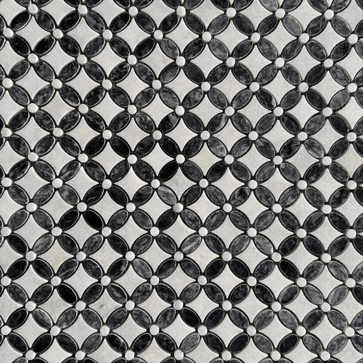 Close detail of the black marble centres and white Carrara petals in the flower motif