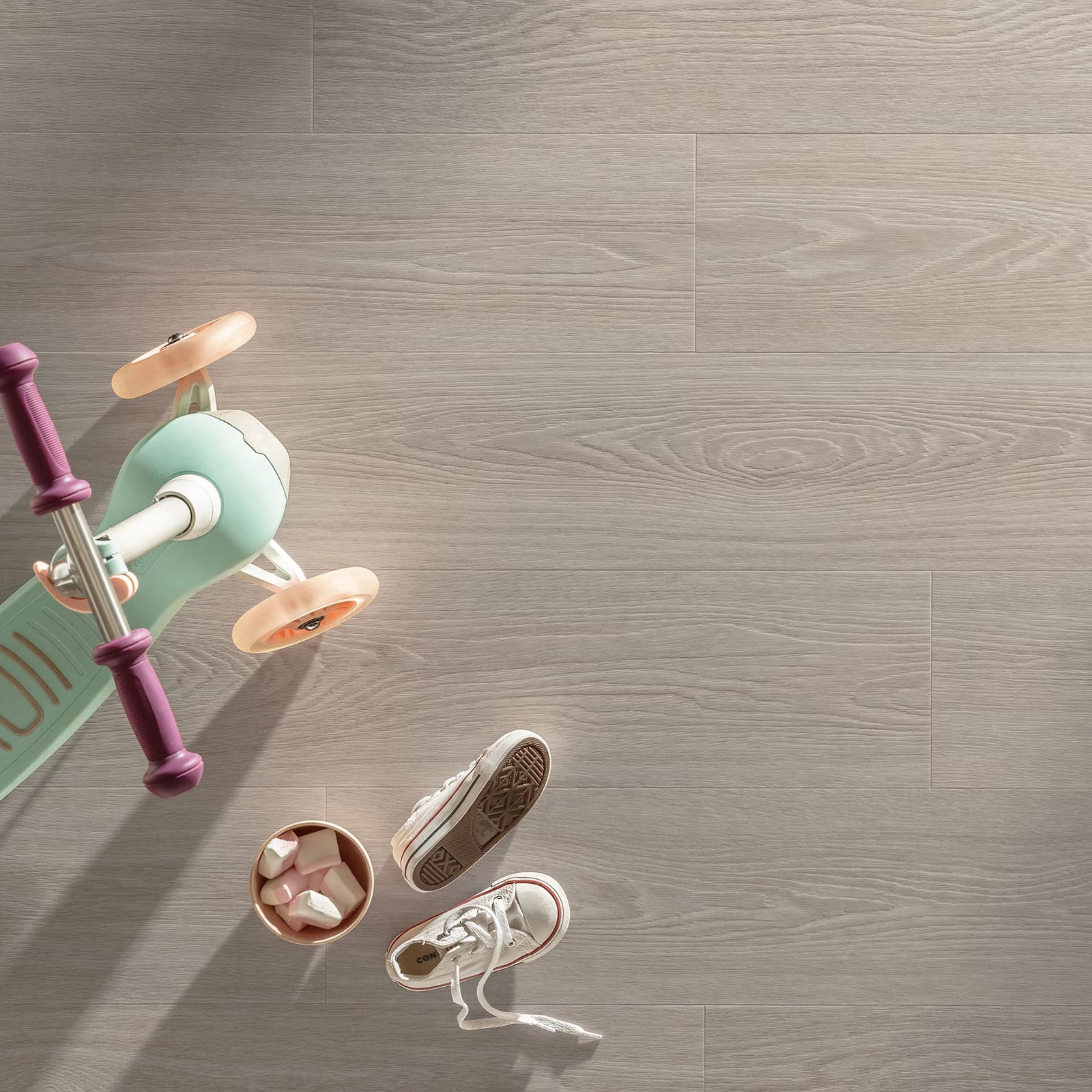 Mint green and purple children’s scooter with peach-colored wheels on bunny f059 vinyl planks flooring