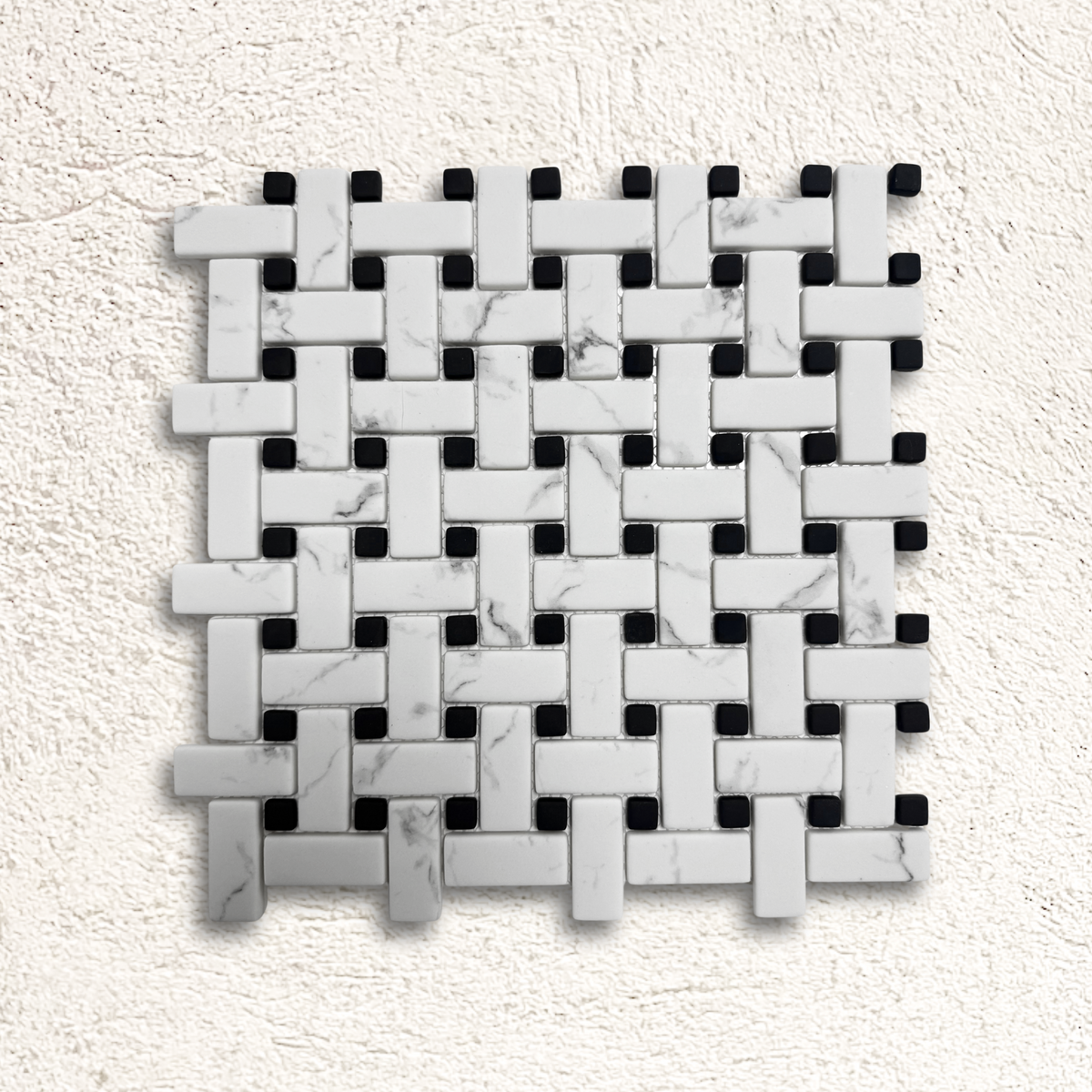 White marble and black mosaic tile in a woven basketweave pattern for ritz carrara mosaic design