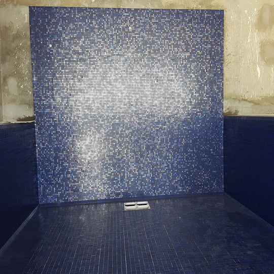 Abalon Azure blue glass mosaic tiles shown as a shower wall
