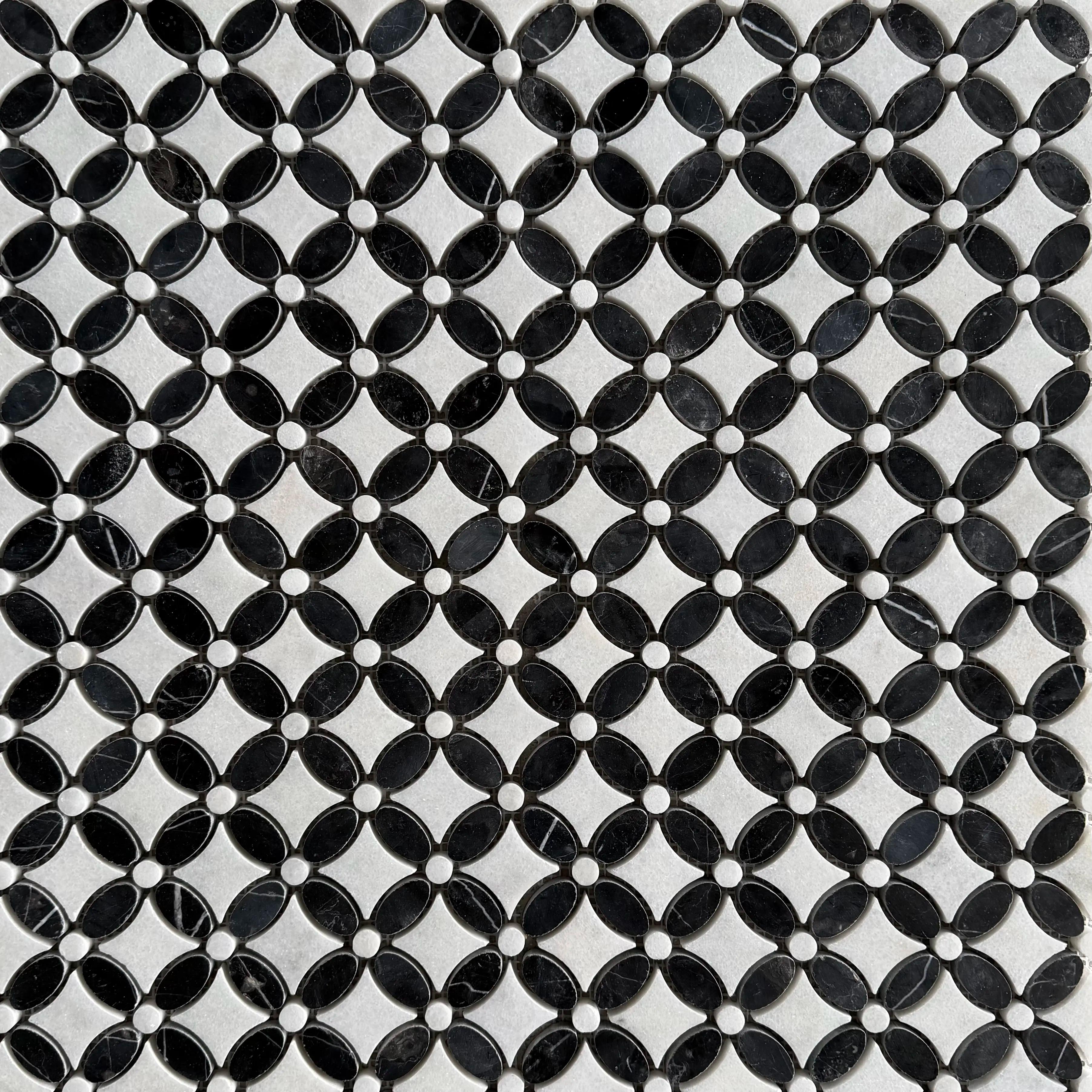 Close detail of polished Nero Marquina and Carrara petals meeting at a grout joint