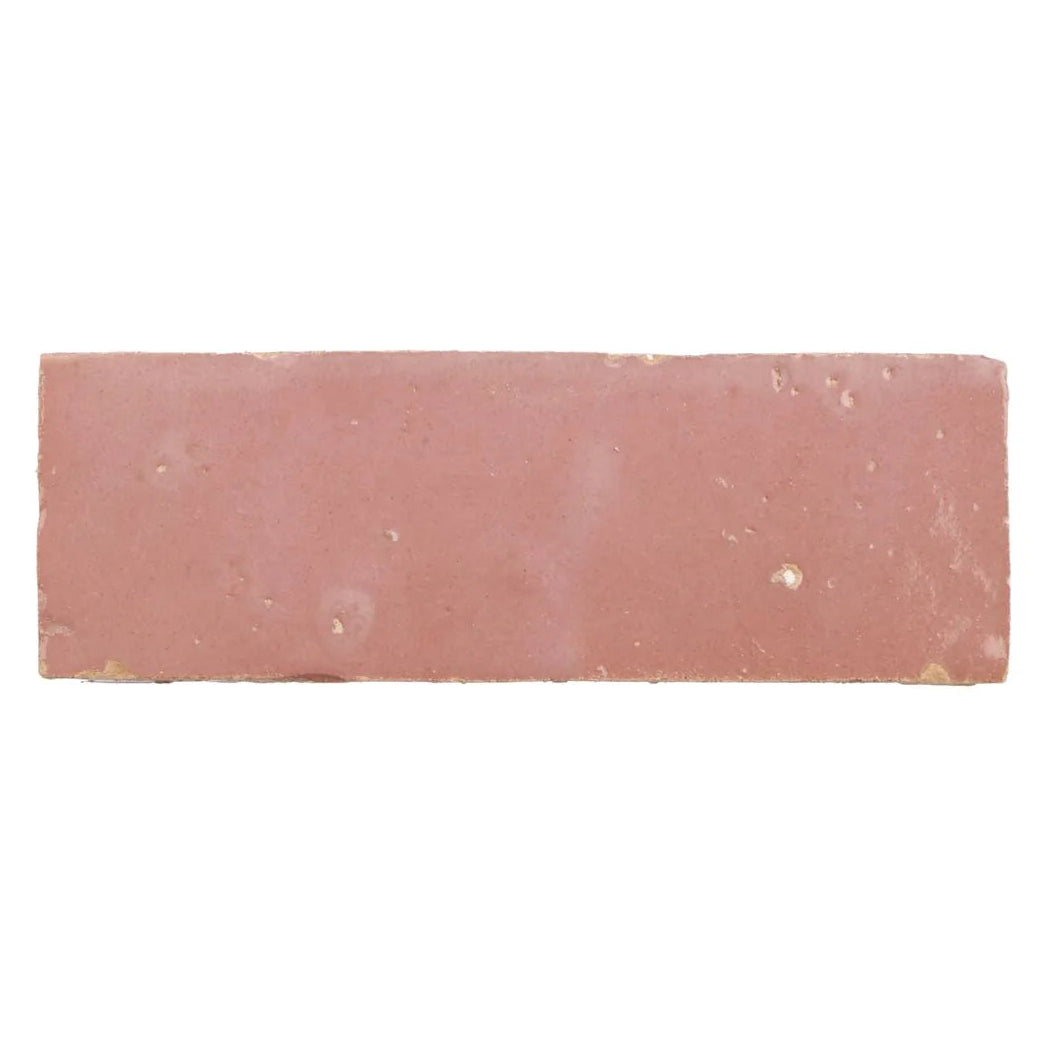 A rectangular handmade moroccan zellige tile with a matte terracotta leather pale finish and subtle surface imperfections