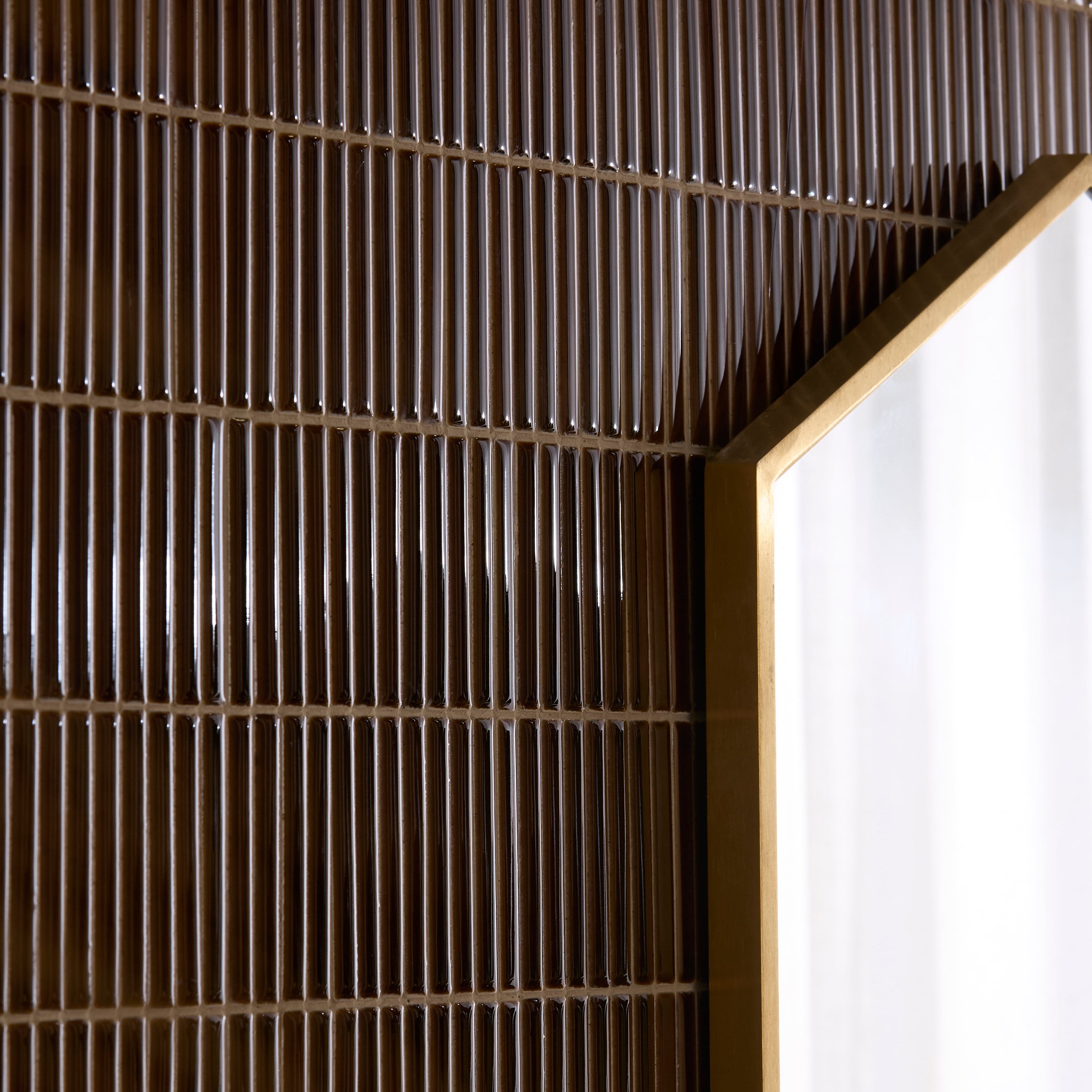 Close-up of a textured brown wall with a white corner.