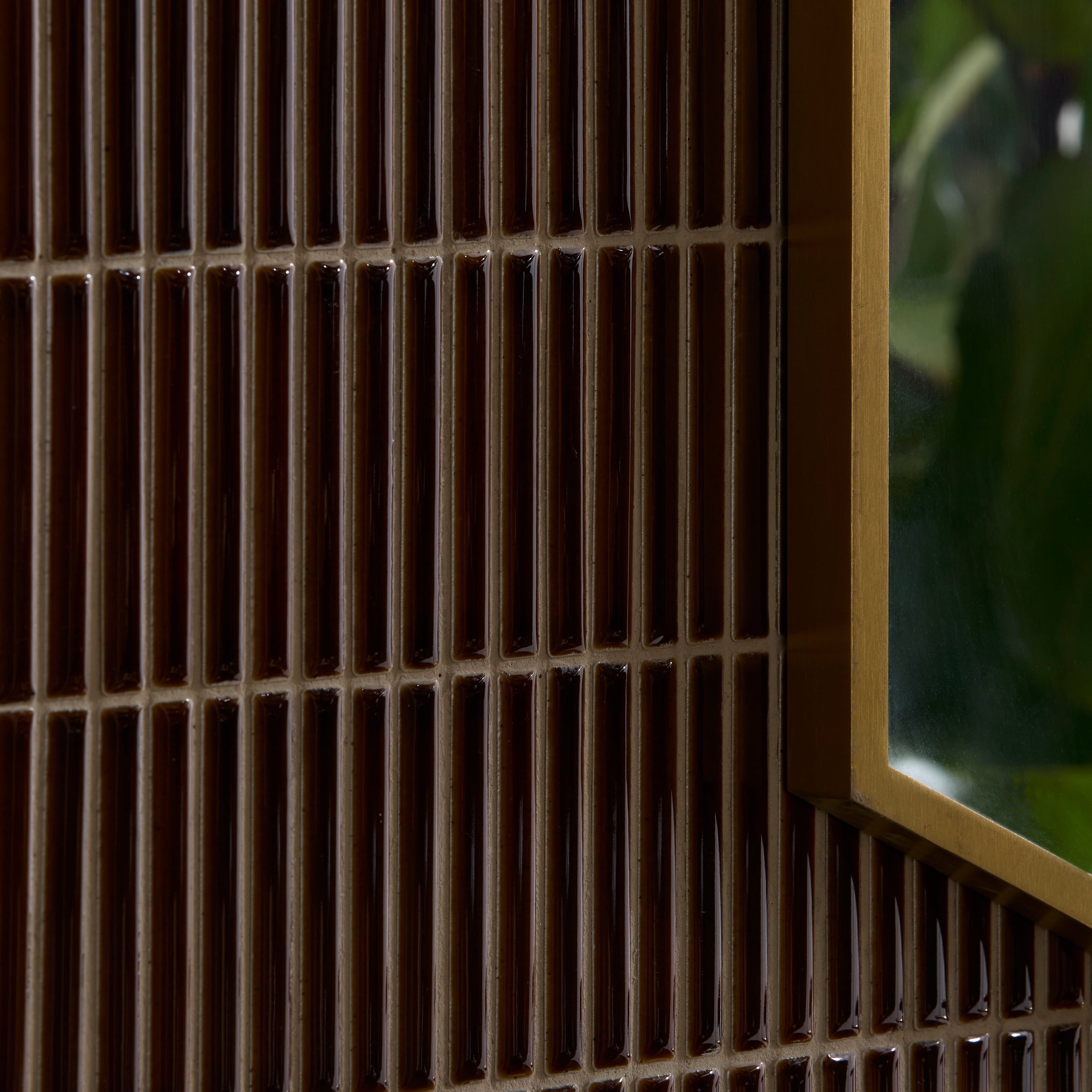 Close-up of a grid pattern with a blurred green leafy background