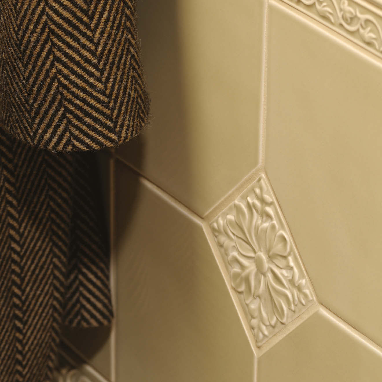 Beaulieu moulding lav lenham cream-colored ceramic tile with raised floral design on diamond-shaped face
