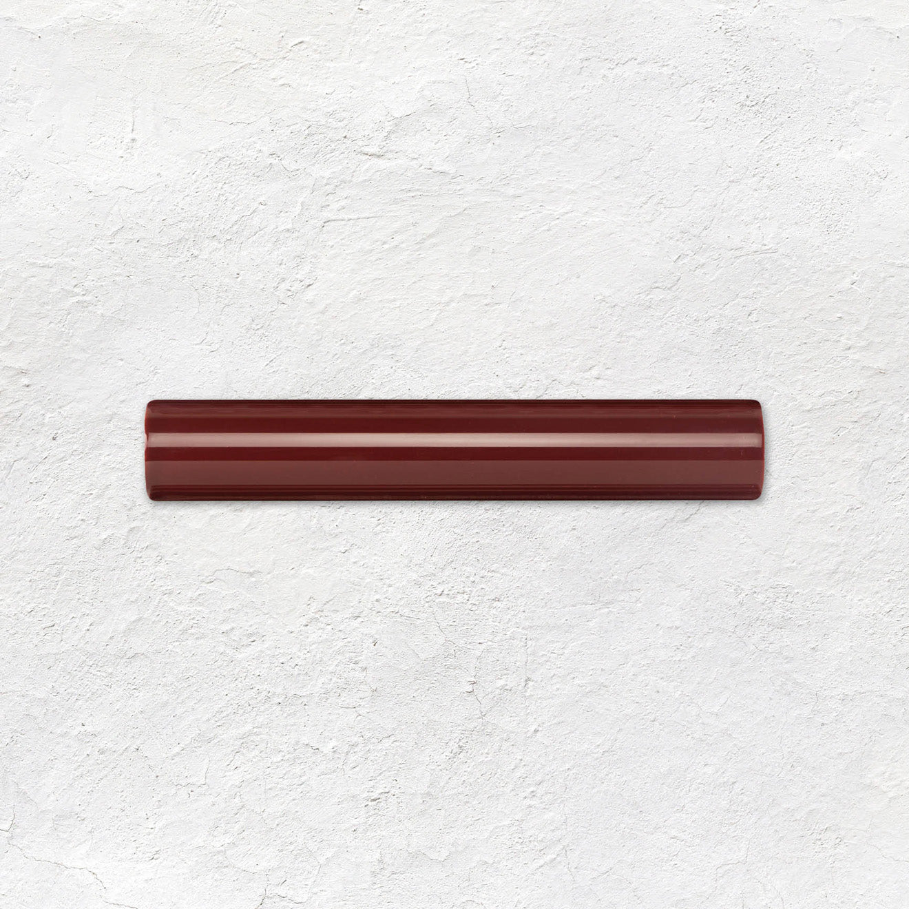 Burgundy Sigma Moulding Ceramic Wall Tile 152x26mm in a bathroom setting