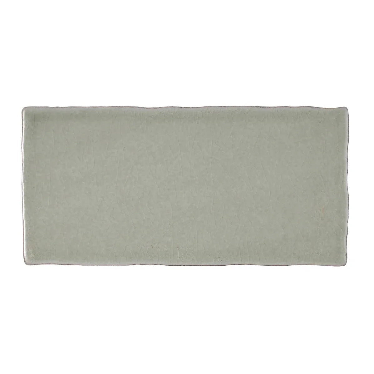 A rectangular matte finished ceramic tile in soft sage green with slightly irregular edges from Carnival Sella Grey Glazed Tile