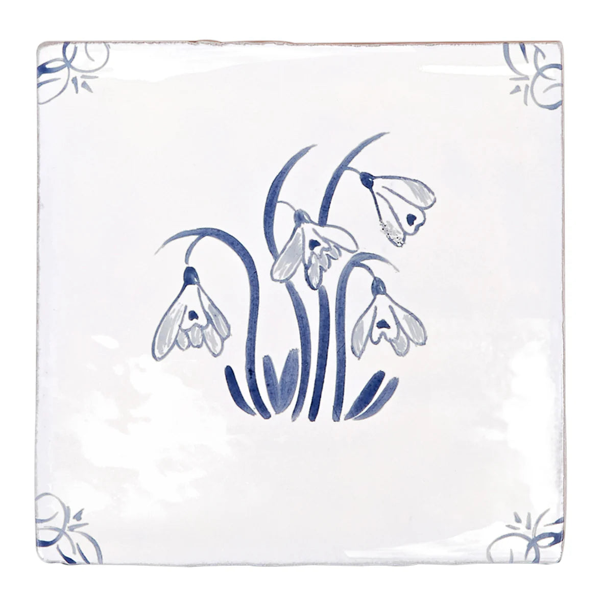 White ceramic english delft snowdrop blue gloss tile with delicate hand-painted blue snowdrops and corner floral motifs