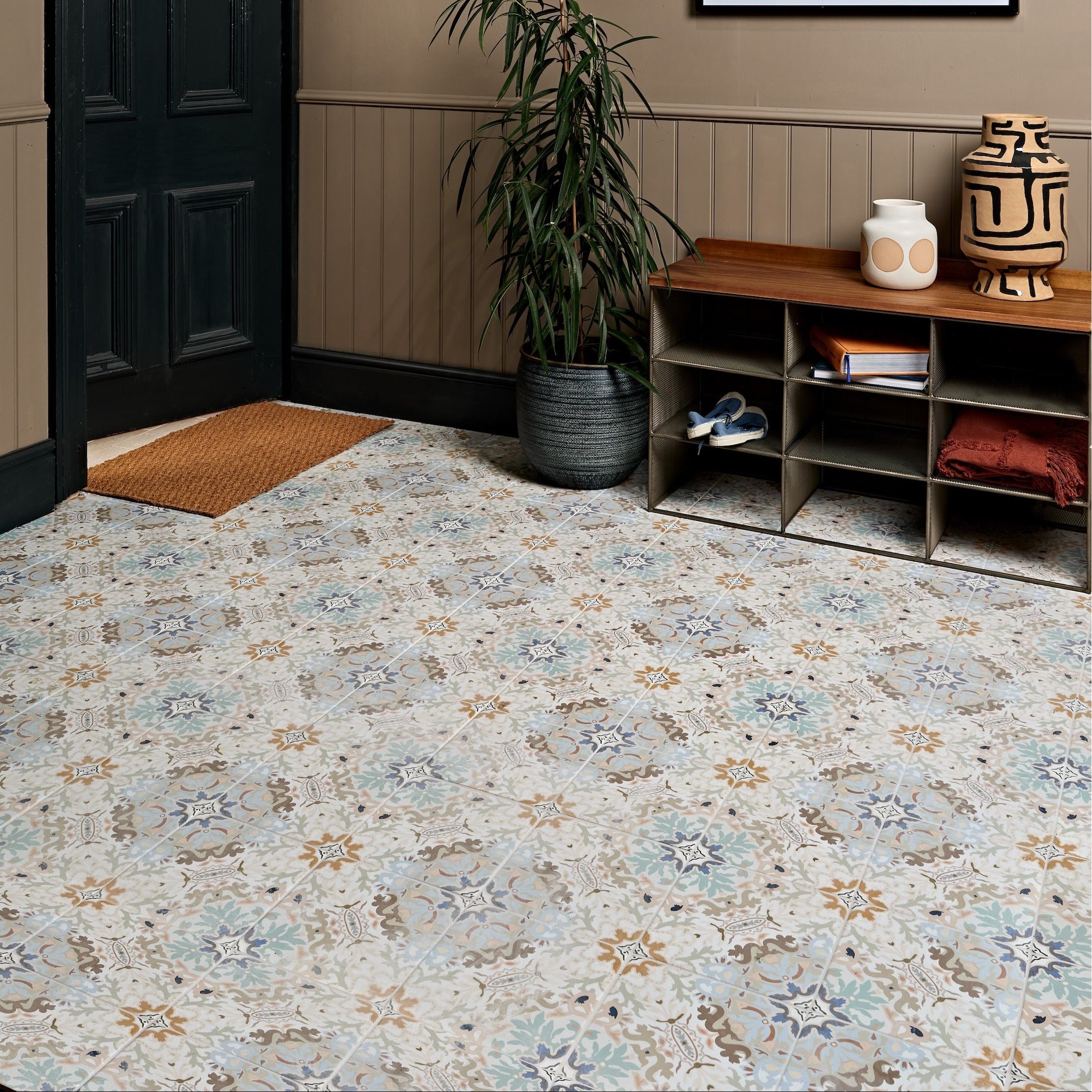 Patterned mosaic floor tiles in muted blue beige and brown with intricate geometric designs kashmir porcelain plaster