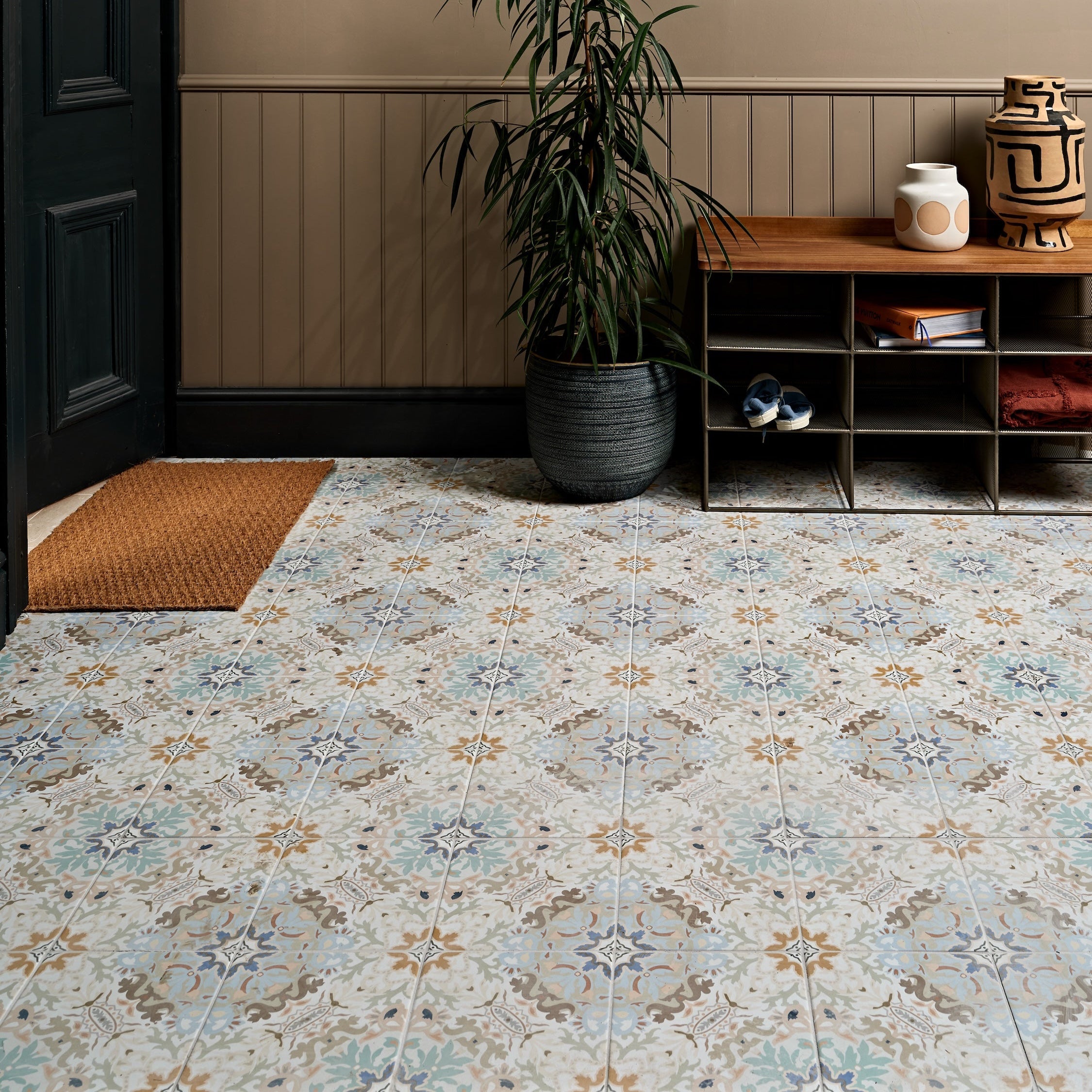 Patterned Kashmir porcelain plaster floor tiles with vintage ornate design in muted blue beige and brown tones