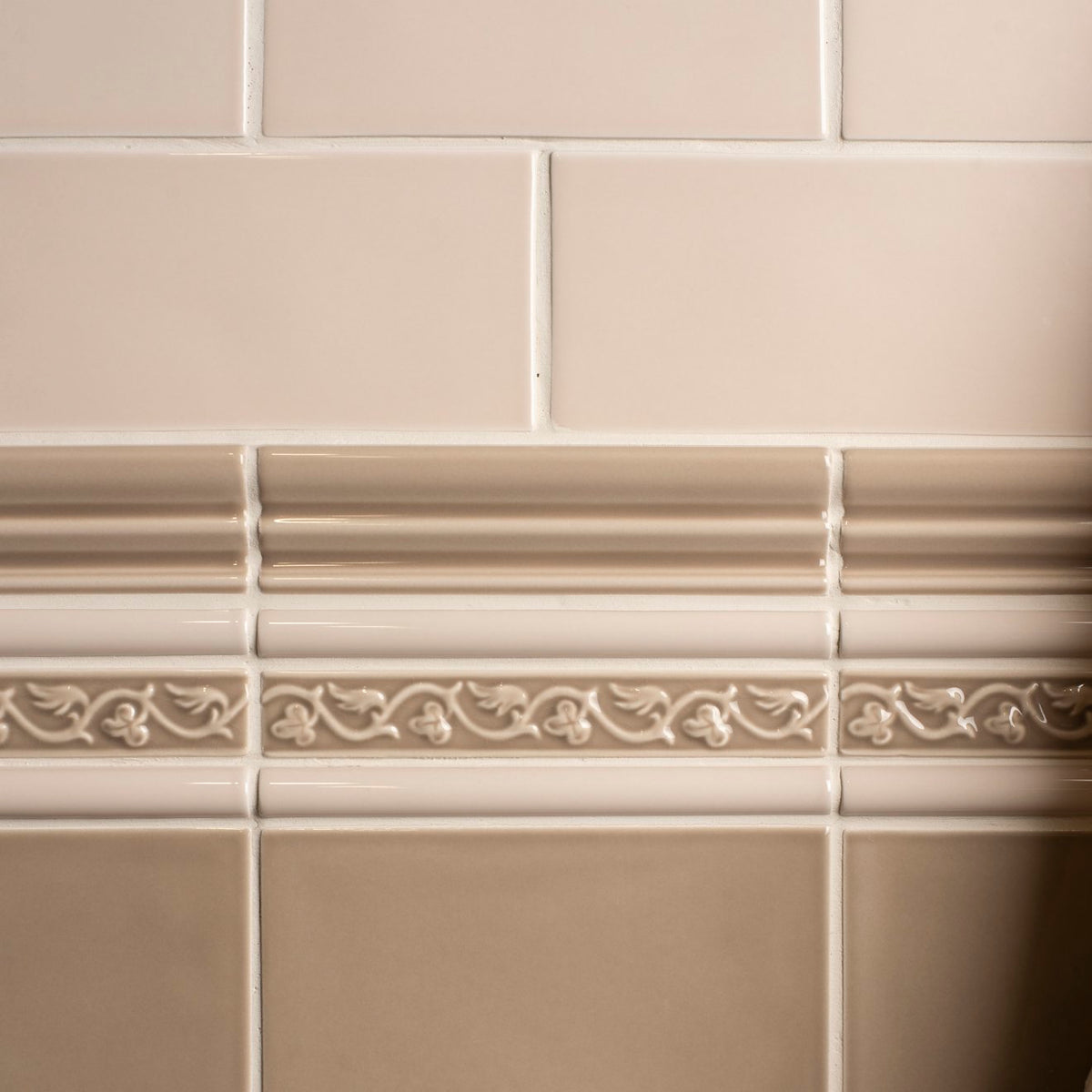 Close-up of beige tiles with decorative border