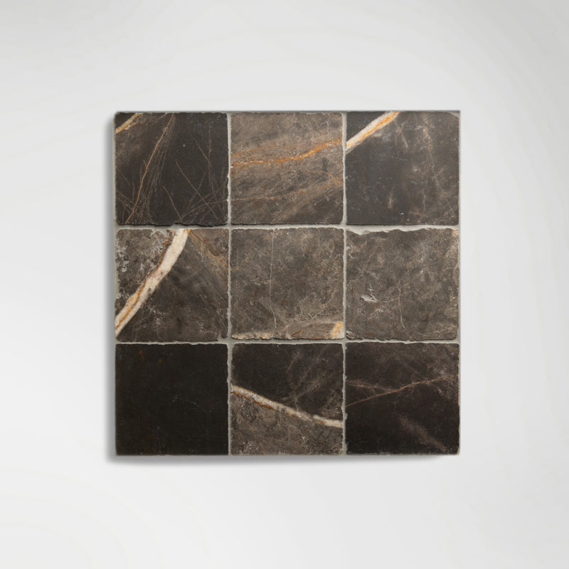 Roman Bronze Fantasy Squares marble tiles laid on a wall