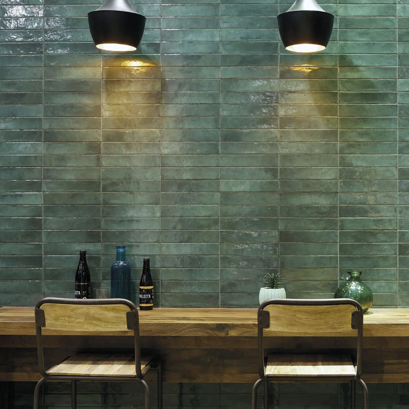 Lisbon Green Jade Shine green ceramic tiles behind a bar counter