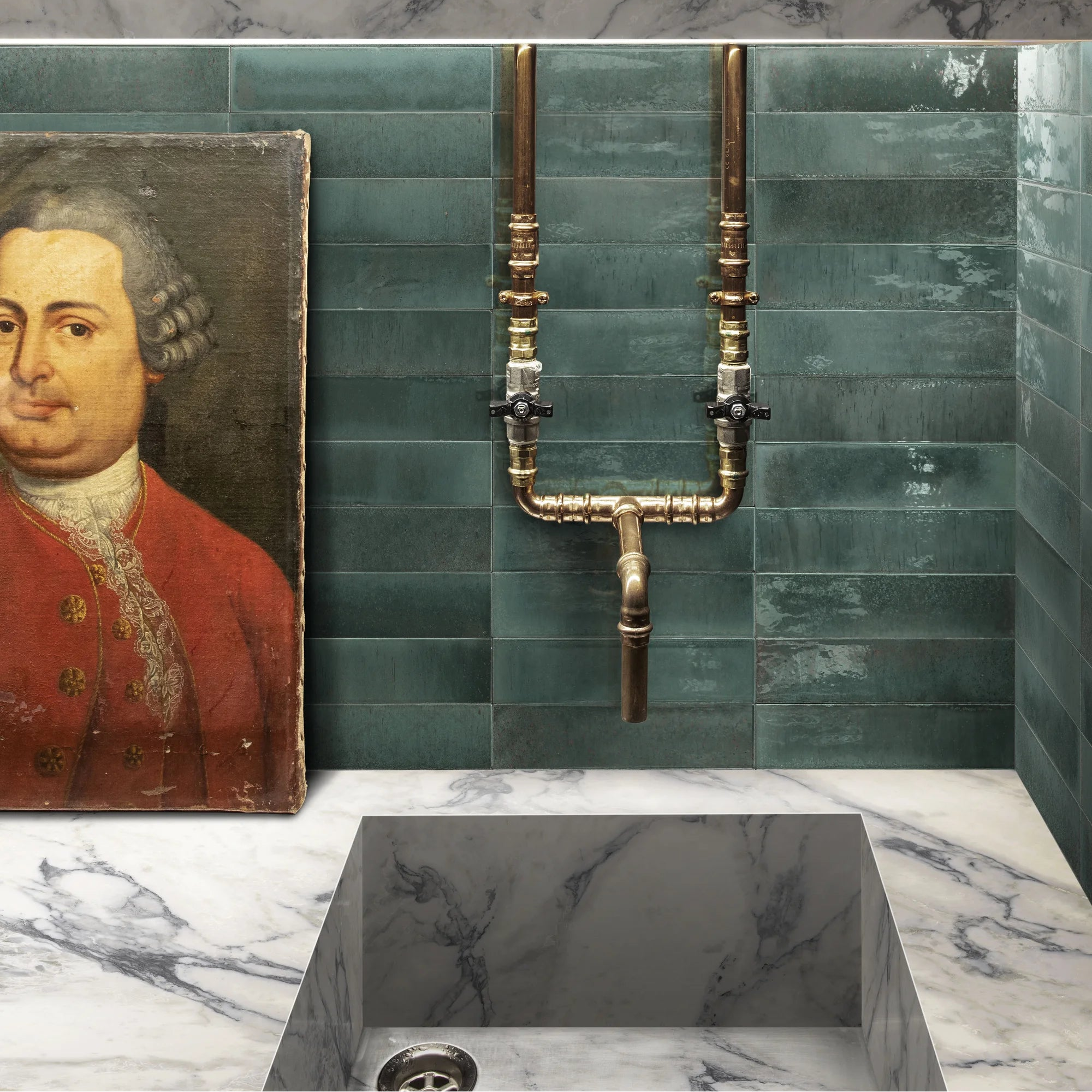 Brass plumbing fixtures with polished finish and black-handled valves on a teal tiled wall in luminous lume turquoise
