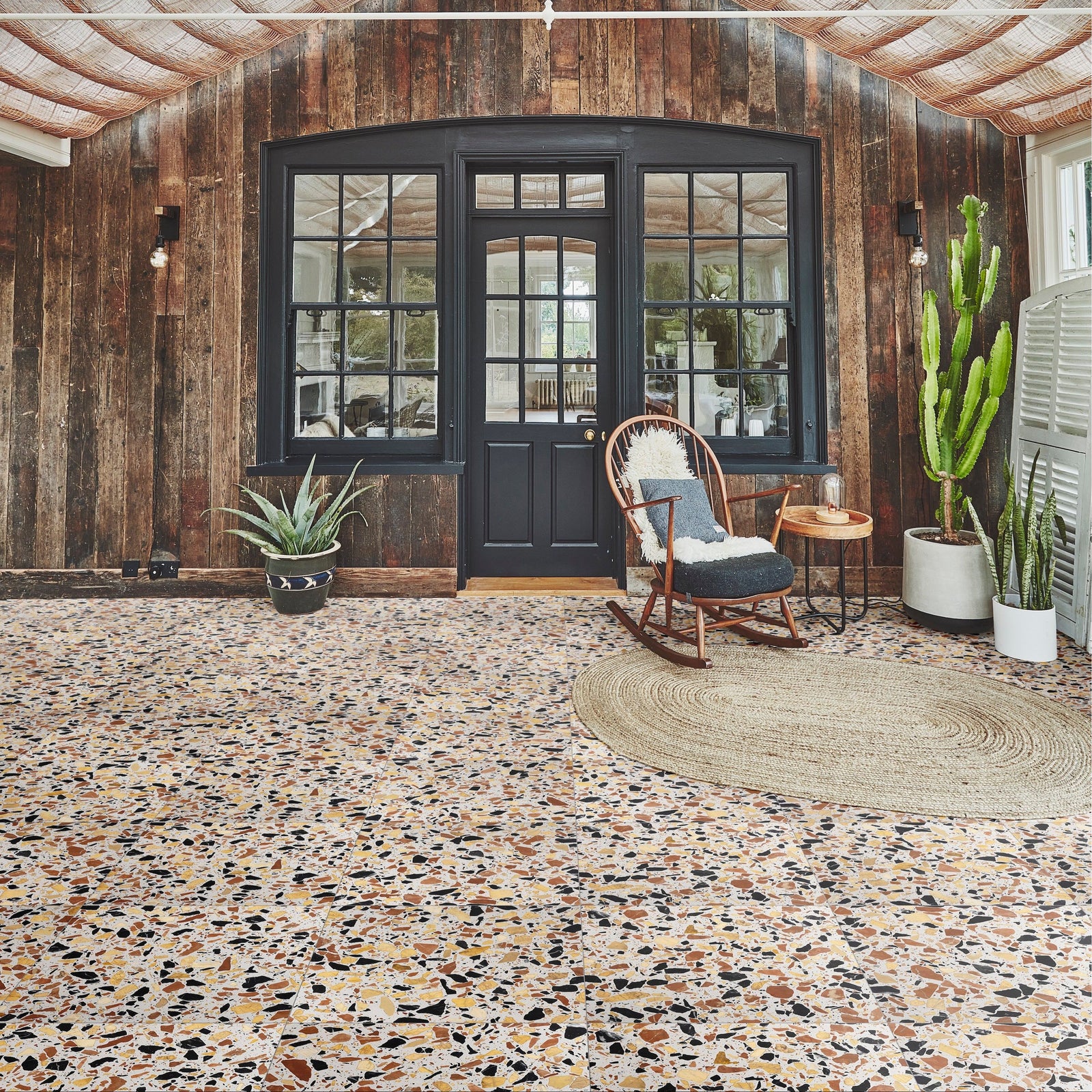 Rialto Terrazzo San Marco Honed white terrazzo tiles with a wooden rocking chair