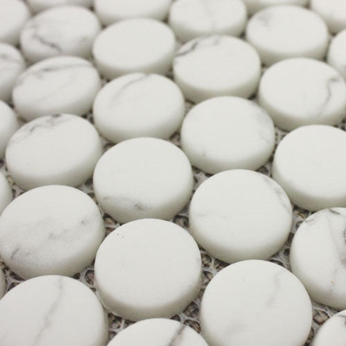 White circular marble mosaic tiles with subtle gray veining from the ritz statuario round mosaic collection
