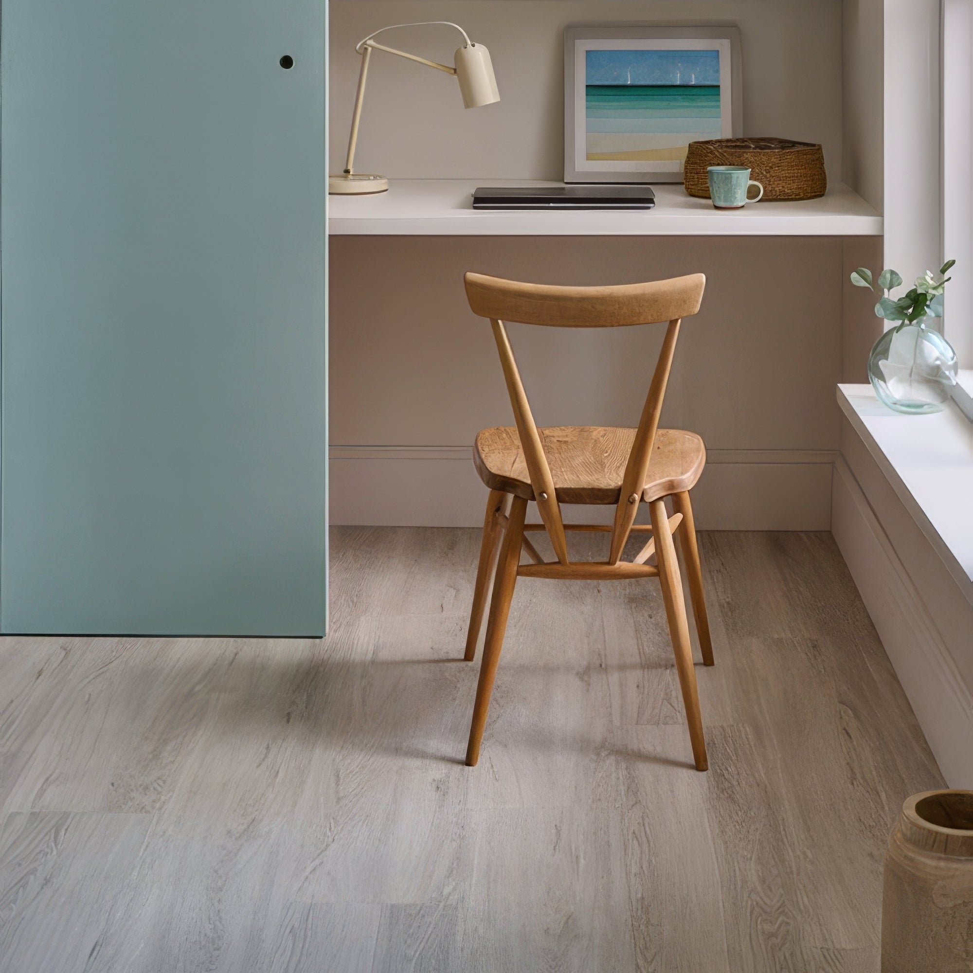 Home office with wooden chair, desk, and shelves with decor items.