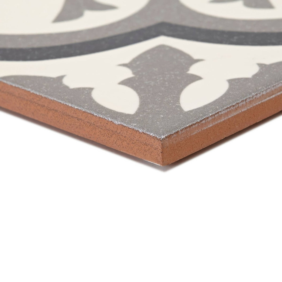 Abbey Waverley border tile featuring a gray and white patterned ceramic tile with a terracotta-colored edge