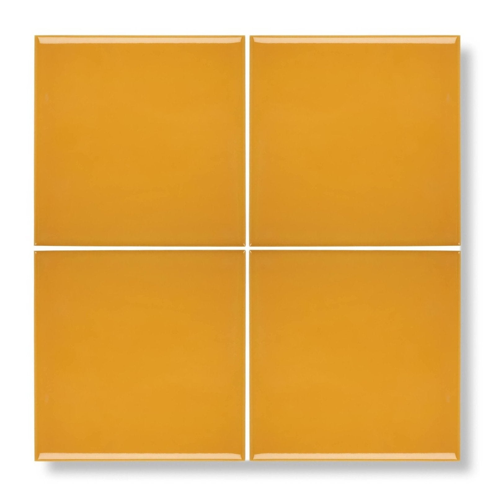 Four glossy mustard yellow square ceramic tiles arranged in a grid acapulco yellow city 10x10cm