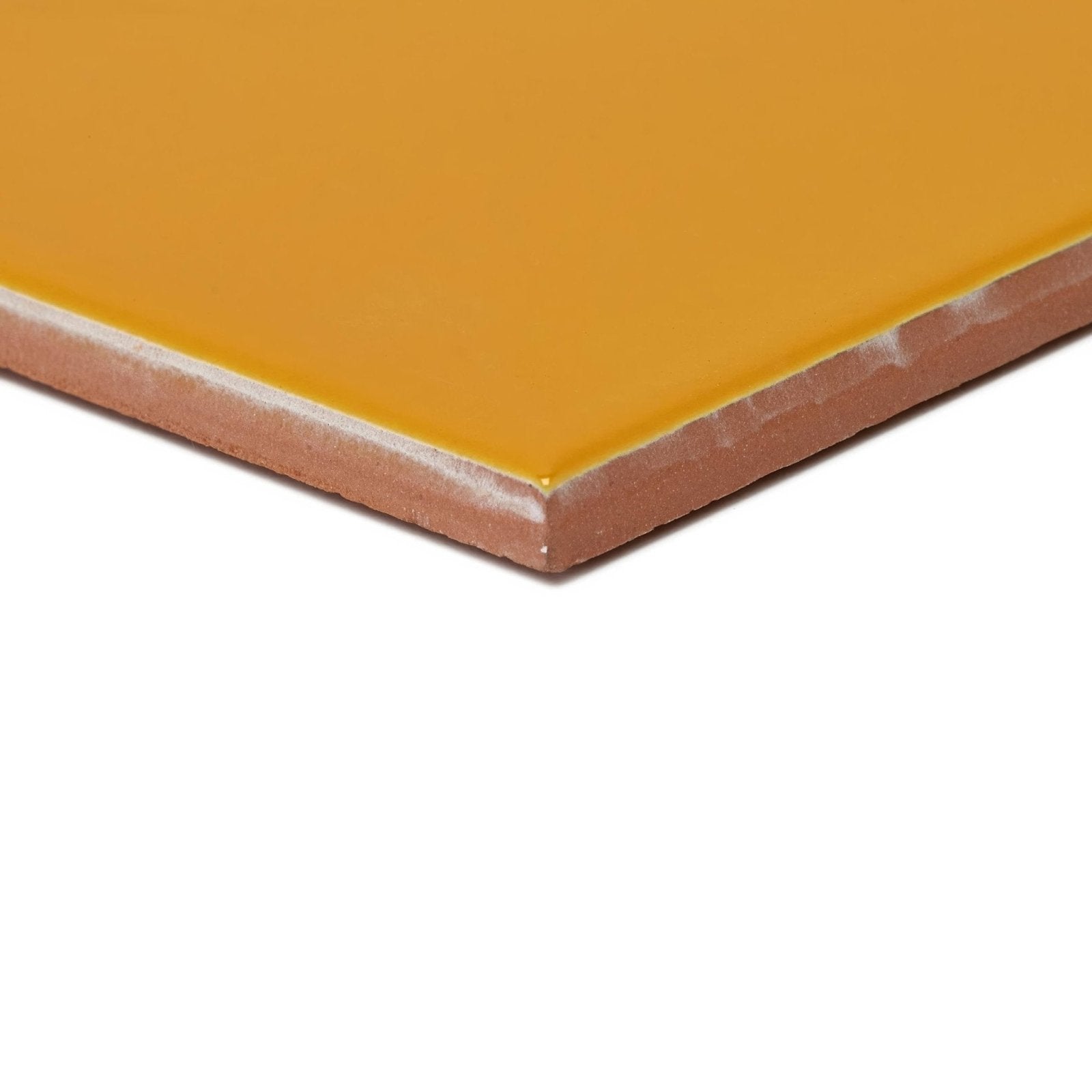 A square ceramic tile acapulco yellow city 10x10cm with glossy mustard yellow glaze and unglazed terracotta edge