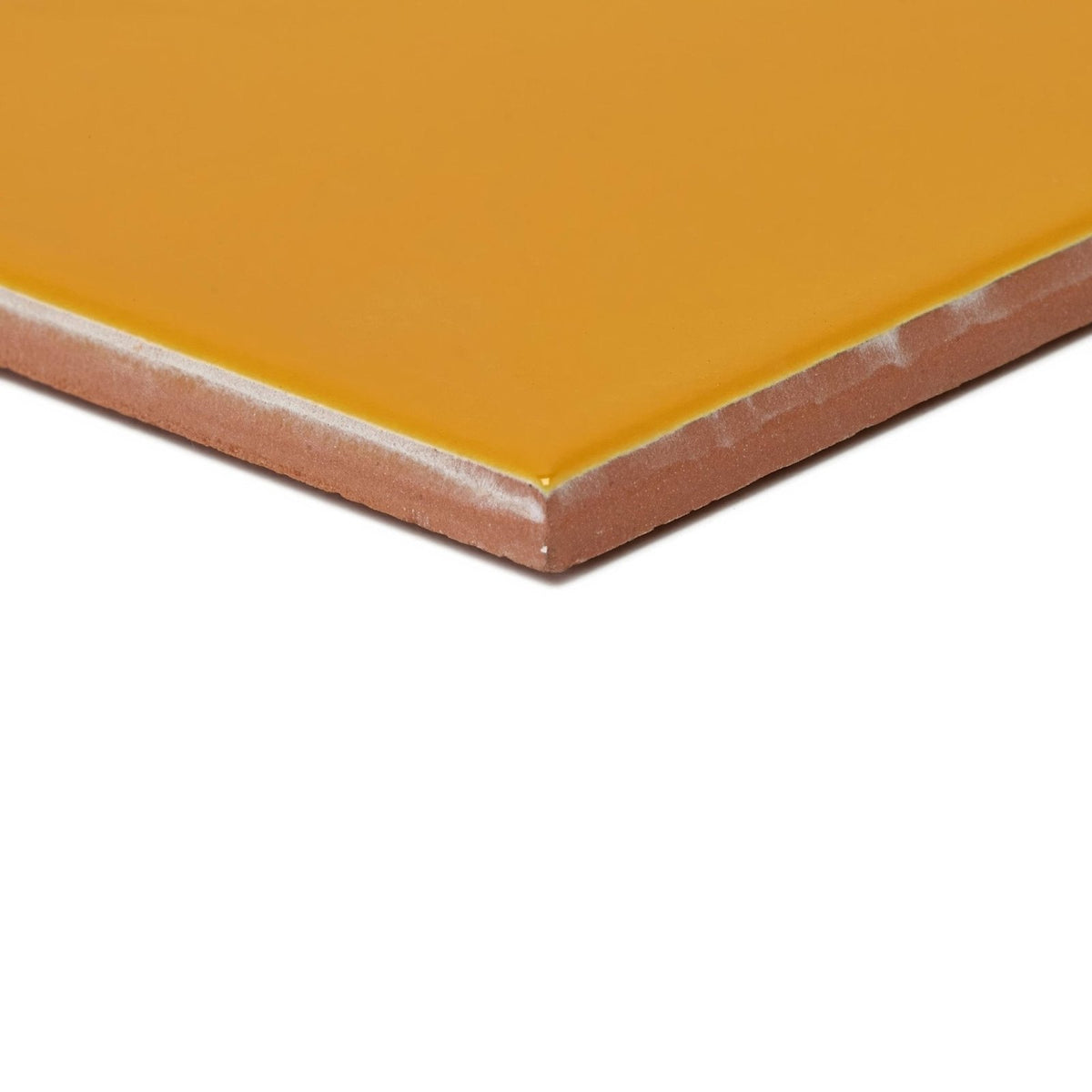 A square ceramic tile acapulco yellow city 10x10cm with glossy mustard yellow glaze and unglazed terracotta edge