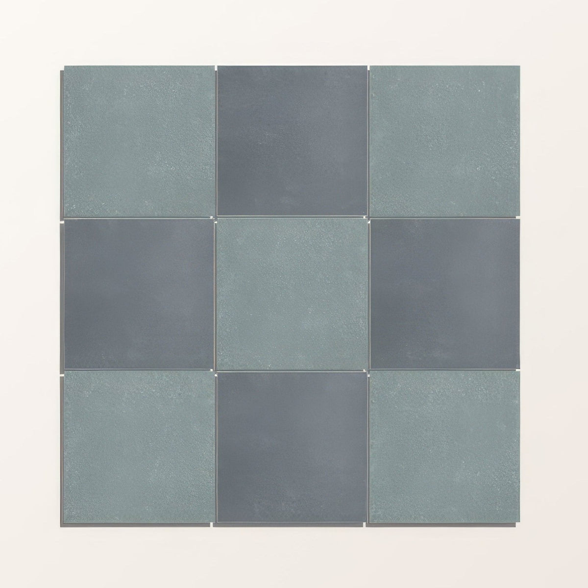 Nine square adventuras blue field porcelain tiles in muted teal and dark gray with a textured finish arranged in a grid