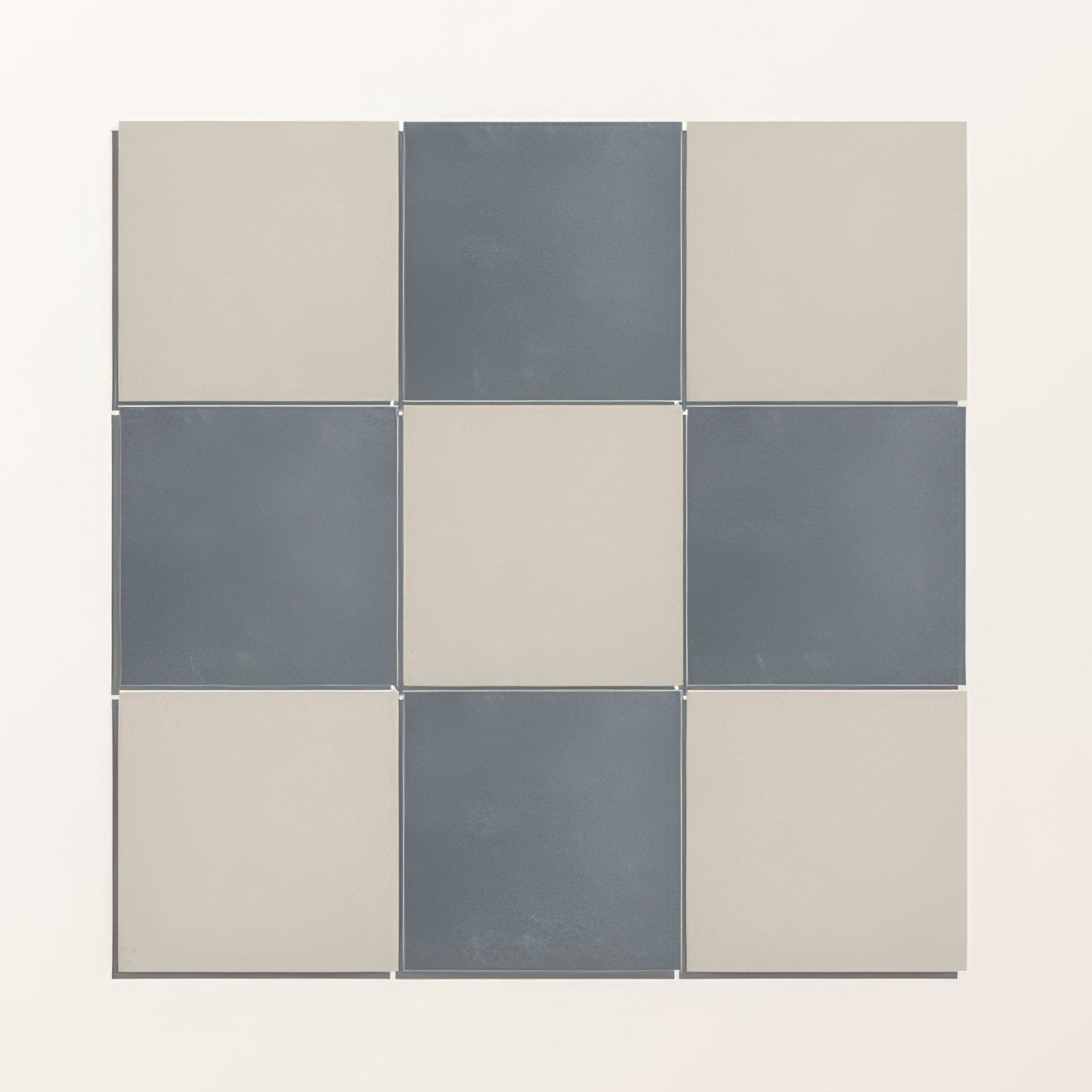 A modern adventuras ecru field porcelain tile set with matte gray and beige checkerboard pattern in 3x3 grid
