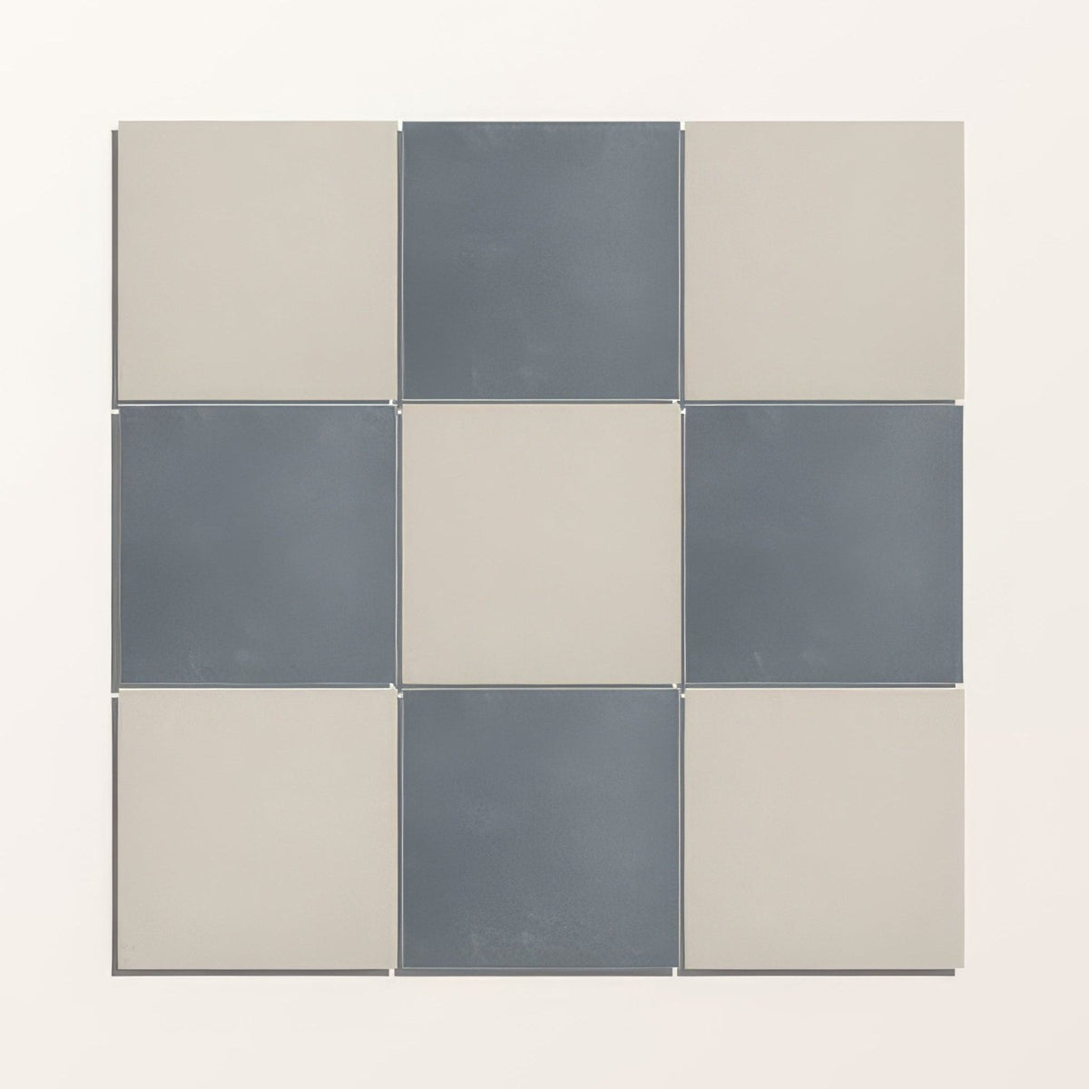 A modern adventuras ecru field porcelain tile set with matte gray and beige checkerboard pattern in 3x3 grid