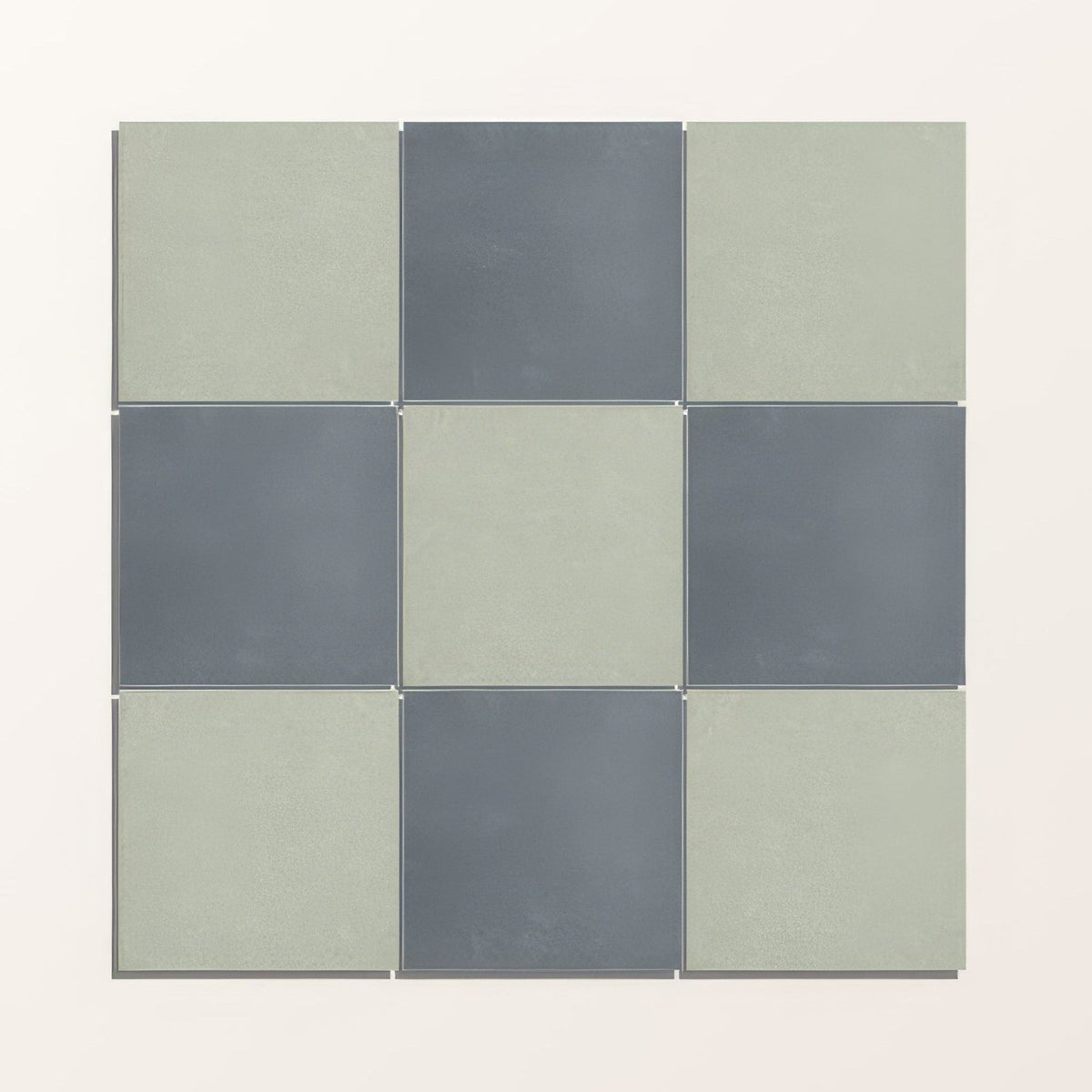 Nine square porcelain tiles from adventuras navy field in matte sage green and muted gray arranged in a 3x3 grid