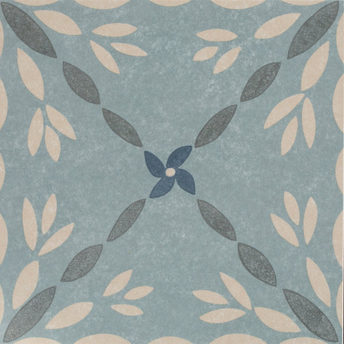 A square porcelain tile adventuras porto blue with a soft blue background and cream dark gray leaf pattern