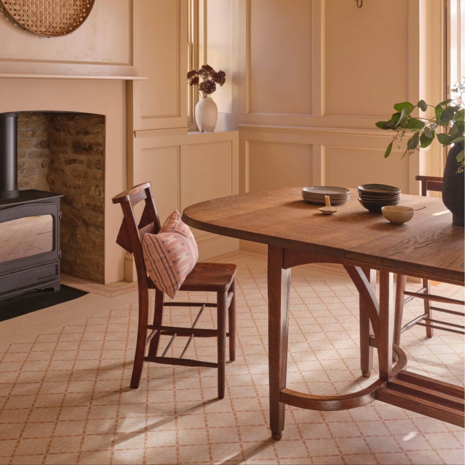 Warm-toned wooden dining table with curved edge and sturdy legs from adventuras porto terracotta porcelain collection