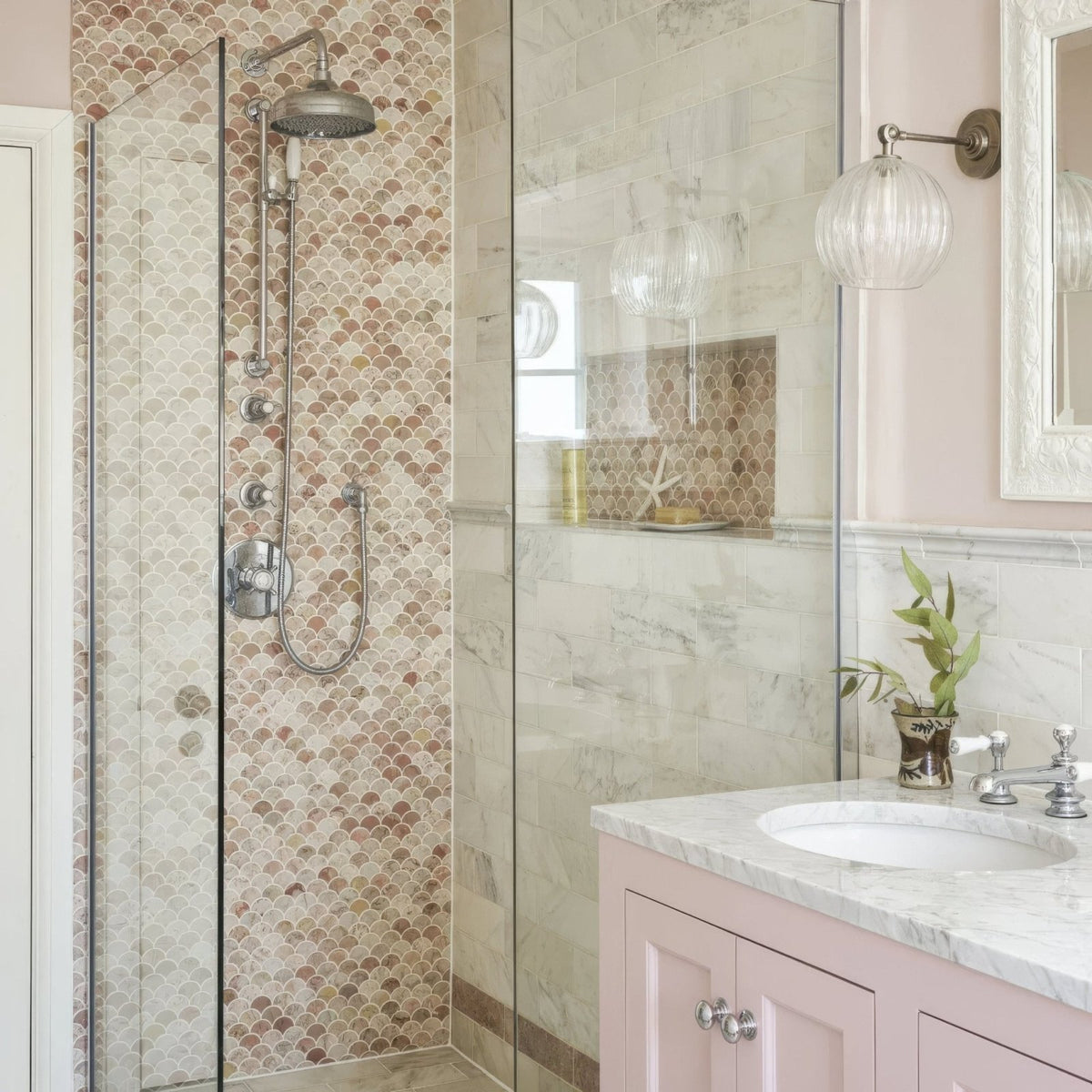 Aegean Pink Scallop Marble Mosaic pink marble scallop mosaic in a shower with a brushed nickel showerhead