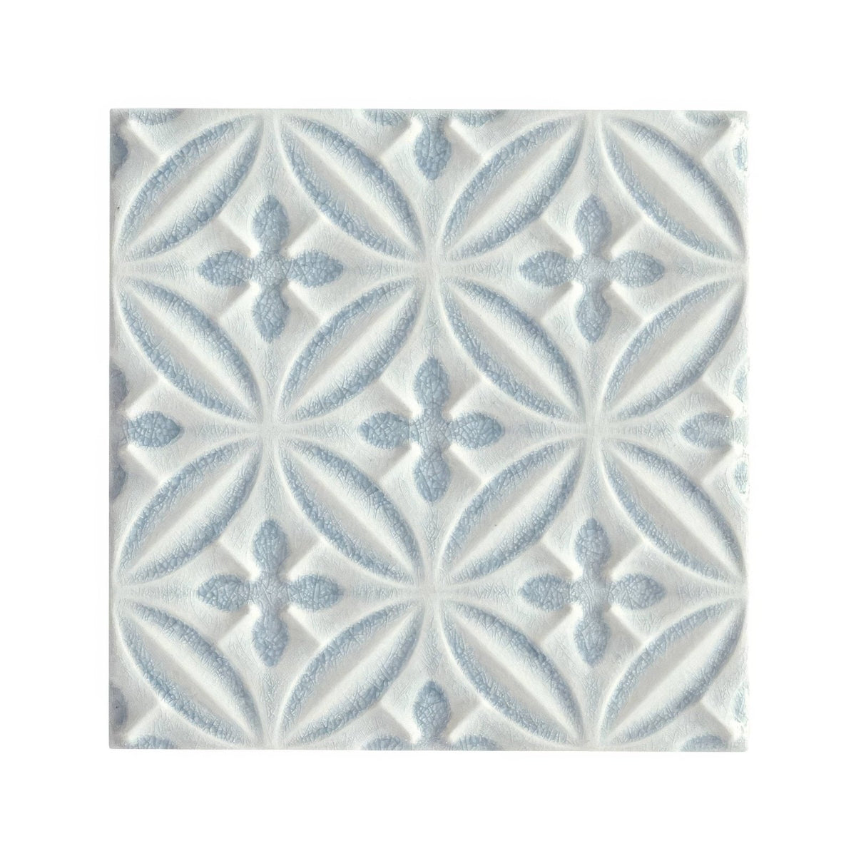 White ceramic glazed tile with subtle light blue embossed floral pattern alhambra blue decor design