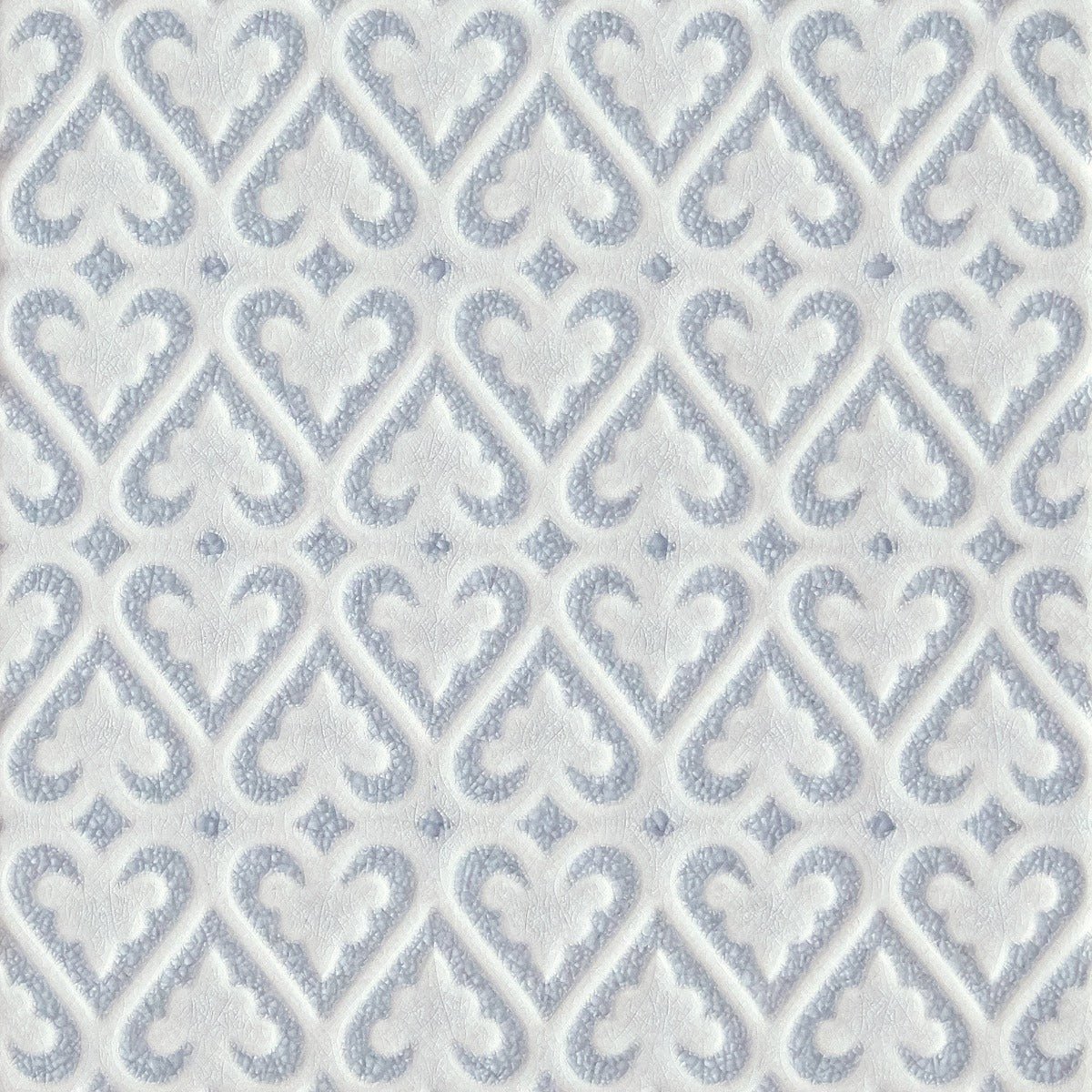 Alhambra blue decor 2 glazed tile featuring white textured wallpaper with a repeating gray damask pattern