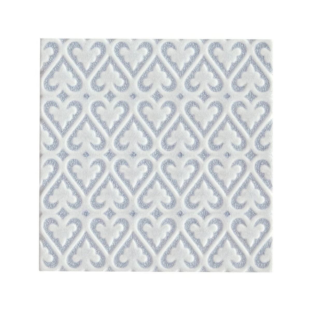White paper napkin with subtle silver embossed damask pattern complementing alhambra blue decor glazed tile