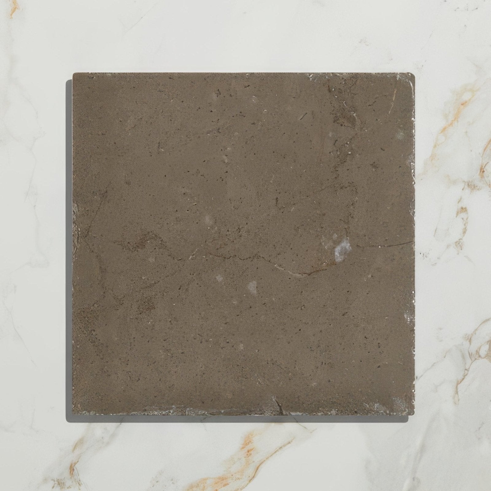 A square dark gray amaya limestone tumbled cabochon with natural veining and slightly rough texture