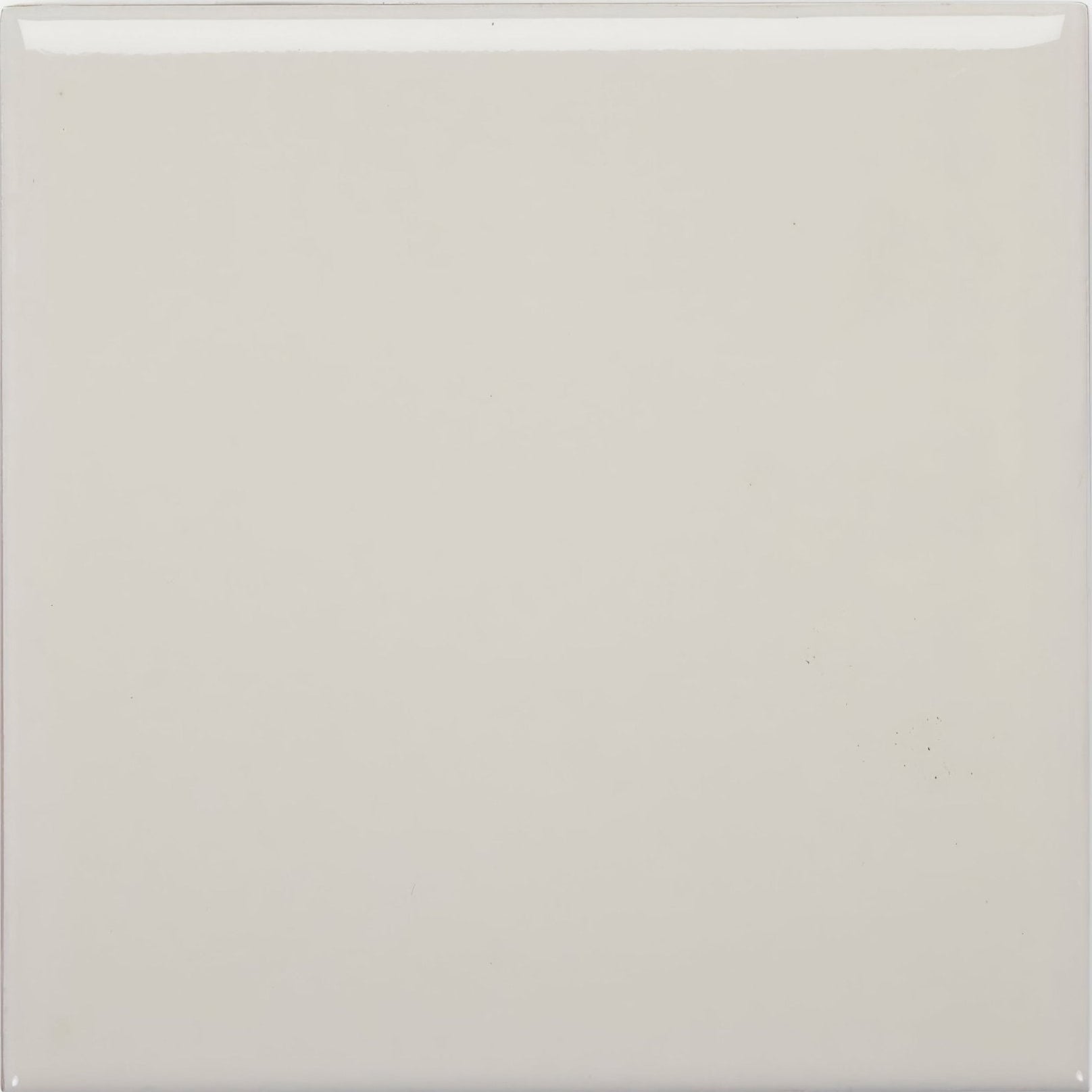 A smooth square ceramic tile in glossy off-white finish called andalucia cream glazed tile