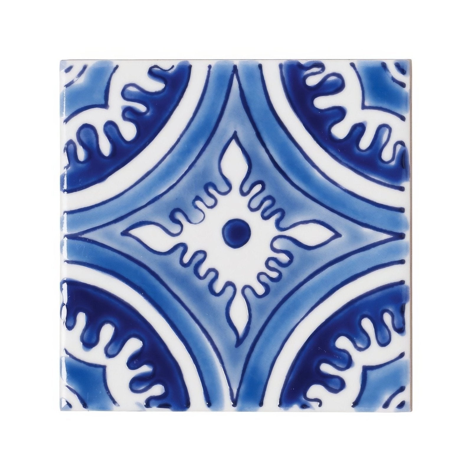 Blue and white ceramic tile with intricate symmetrical floral patterns from andalucia hacienda collection